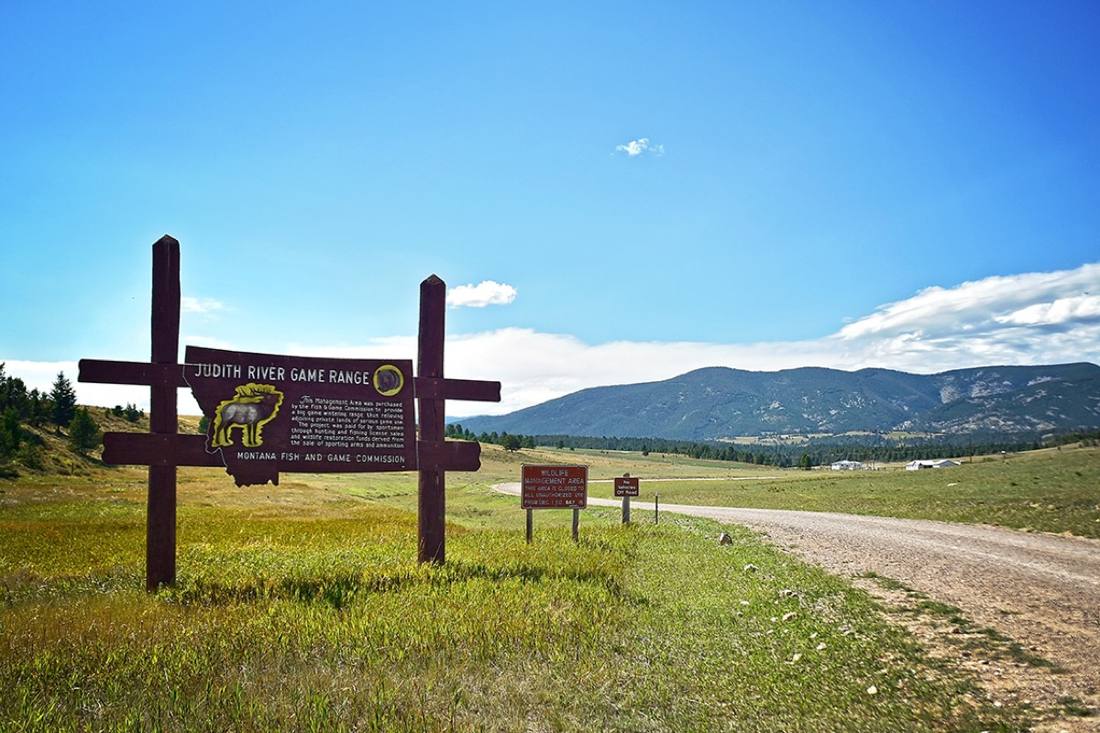 Judith River Game Range sign beside a gravel road
